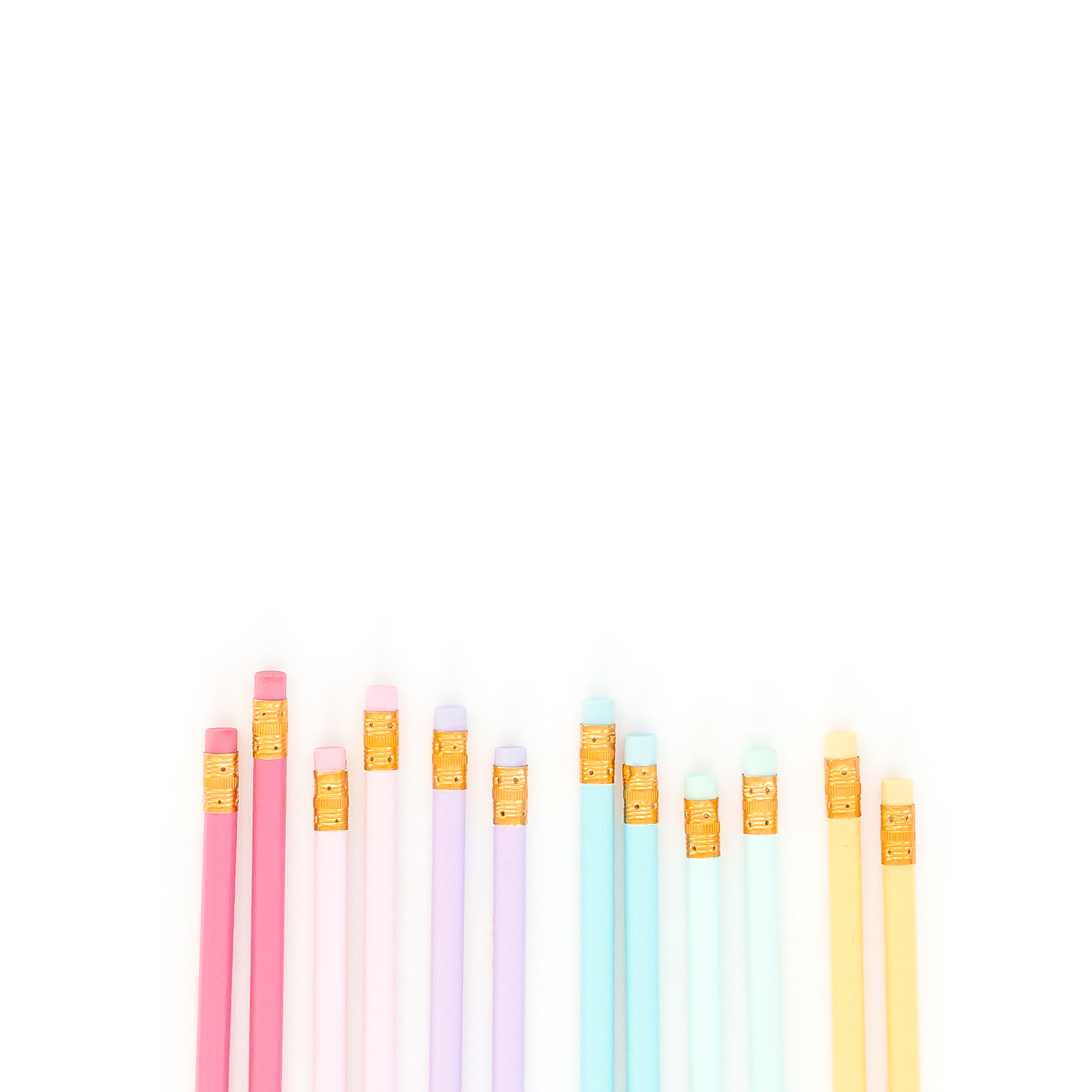 colorful pencils in a row on paper used for copywriting